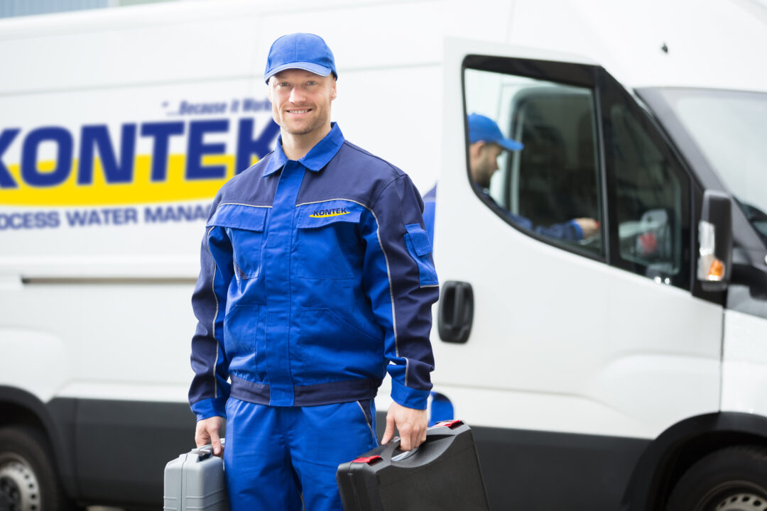 Kontek service technician standing in front of a Kontek service truck
